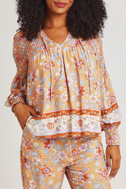 Model Ziara wearing size 10 of the Margie Top in colour Paisley, from the front, cropped image