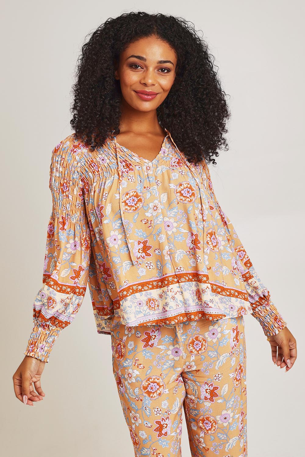 Model Ziara wearing size 10 of the Margie Top in colour Paisley, from the front, cropped image