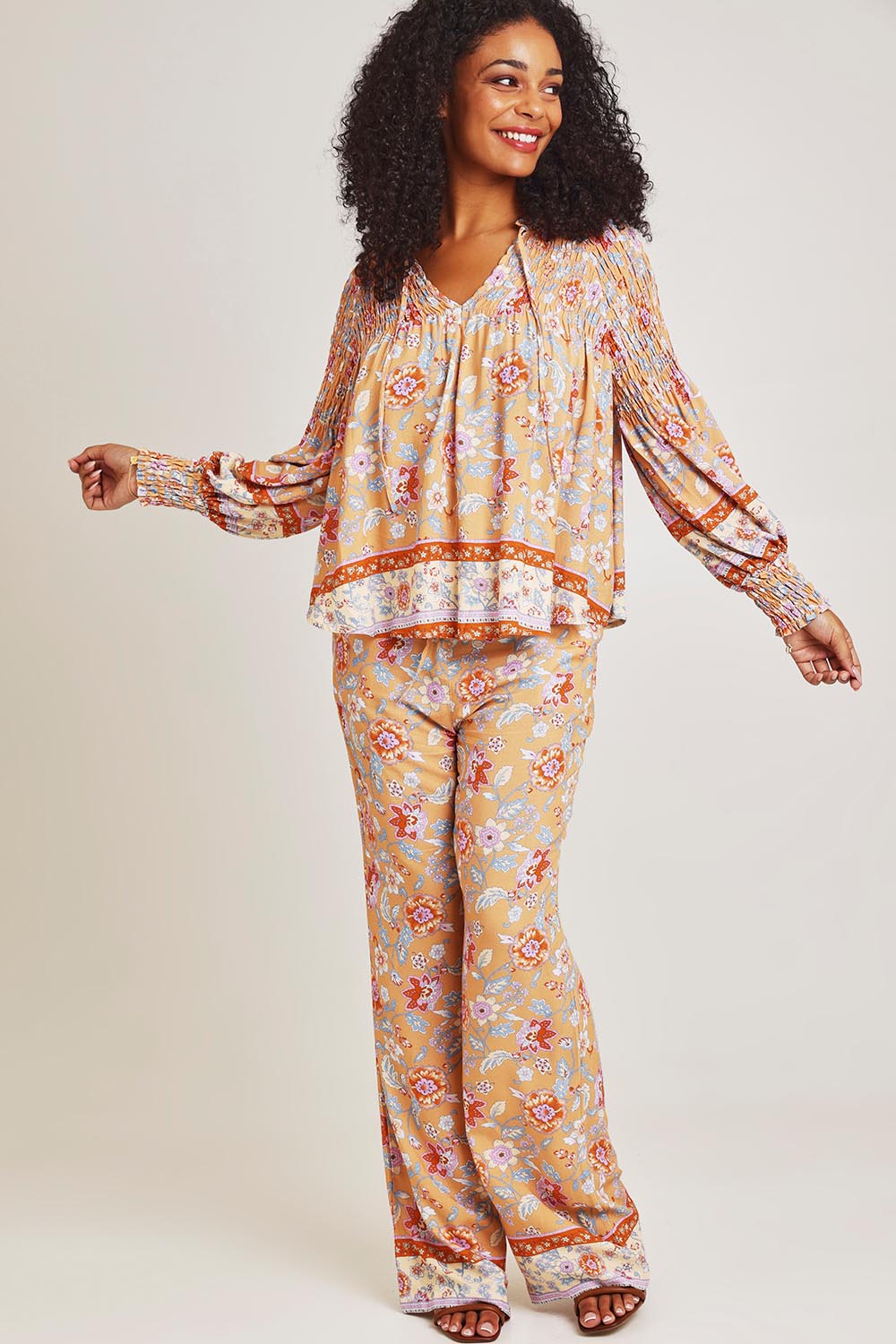 Model Ziara wearing size 10 of the Margie Top in colour Paisley, from the front, showing the whole outfit