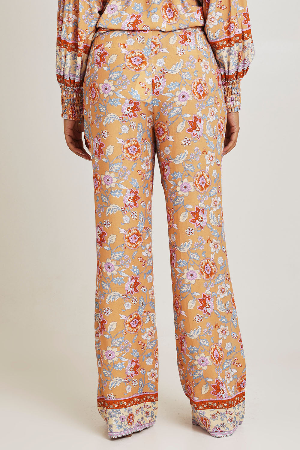 Model Ziara wearing size 10 of the Margie Pant in colour Paisley, from the back