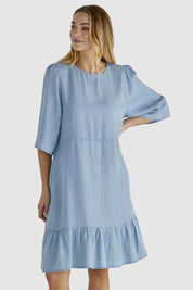 A model wearing the Rye Lyocell Dress in colour Chambray (Blue), from the front, cropped image