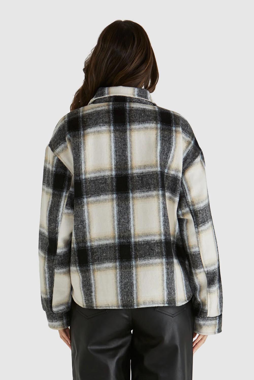 A model wearing the Zita Jacket in colour Charcoal (Grey), from the back