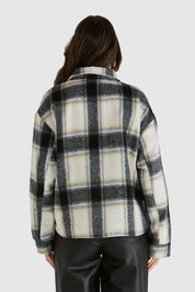A model wearing the Zita Jacket in colour Charcoal (Grey), from the back