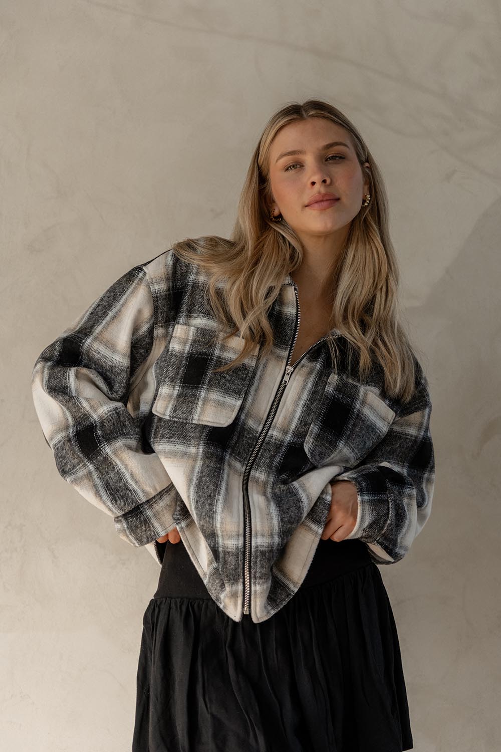 A model wearing the Zita Jacket in colour Charcoal (Grey), from the front, showing the whole outfit