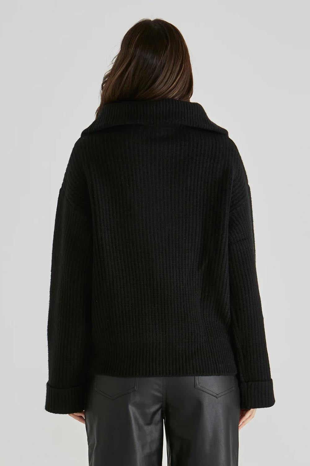 A model wearing the Bennett Knit Jumper in colour Black (Black), from the back