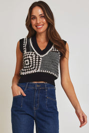 Model Madeline wearing size 10 of the Erika Cotton Crochet Vest in colour Blkwhite (Black), from the front, cropped image