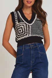 Model Madeline wearing size 10 of the Erika Cotton Crochet Vest in colour Blkwhite (Black), from the front, cropped image