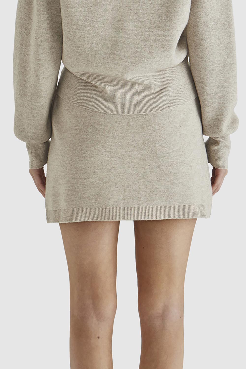 A model wearing the Baldwin Cotton Blend Knit Skirt in colour Oatmeal, from the back