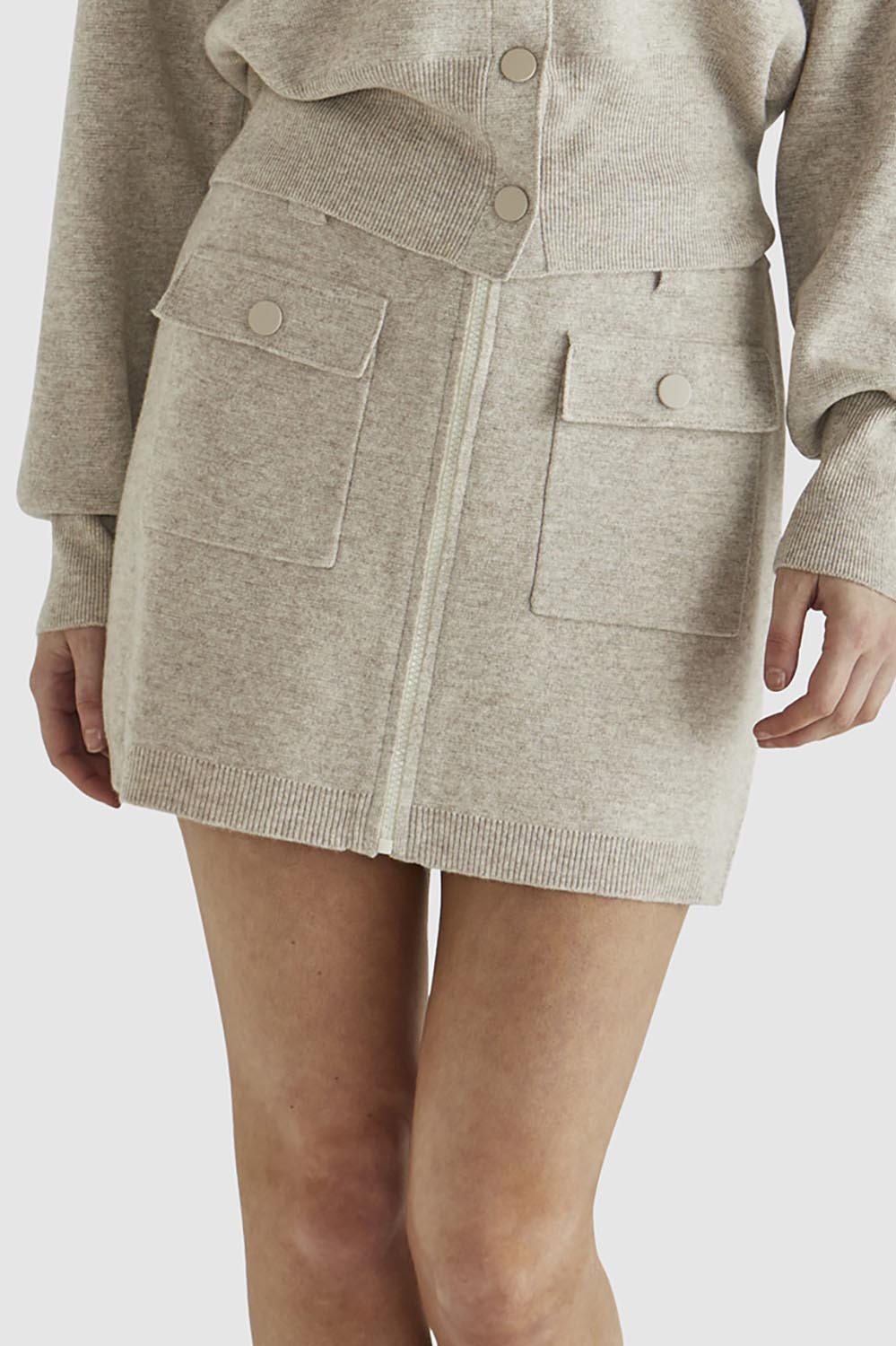A model wearing the Baldwin Cotton Blend Knit Skirt in colour Oatmeal, from the front, cropped image