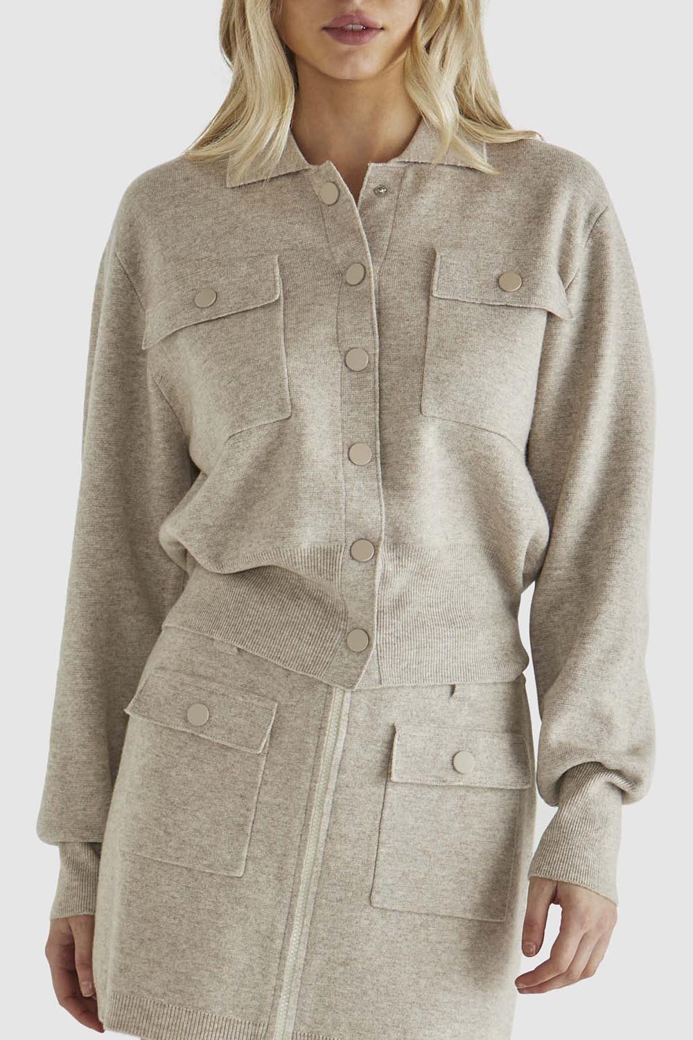 A model wearing the Baldwin Cotton Blend Knit Jacket in colour Oatmeal, from the front, cropped image