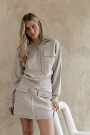 A model wearing the Baldwin Cotton Blend Knit Jacket in colour Oatmeal, from the front, showing the whole outfit