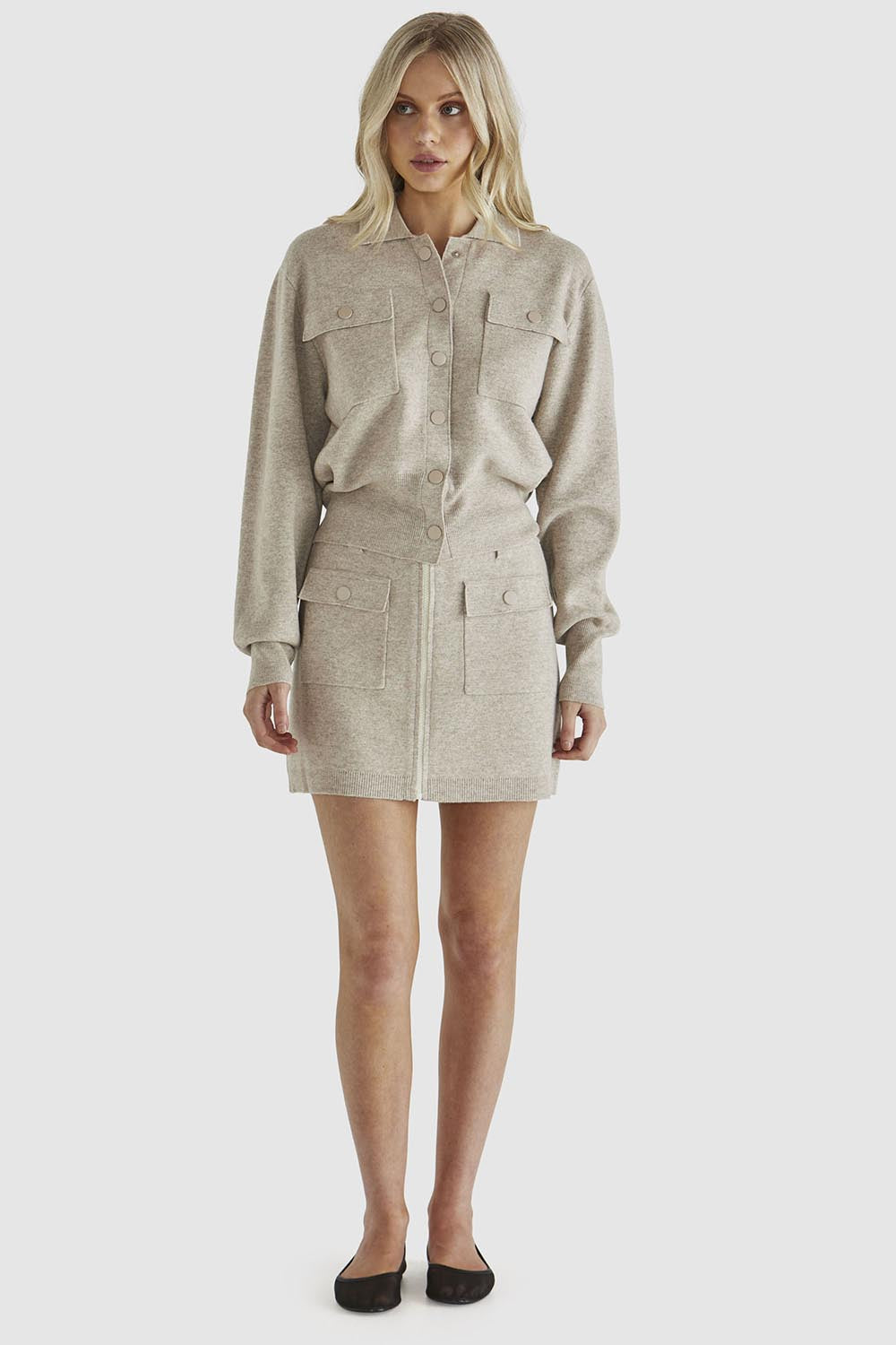 A model wearing the Baldwin Cotton Blend Knit Jacket in colour Oatmeal, from the front, showing the whole outfit
