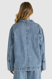 A model wearing the Jordon Top in colour Acidwash (Blue), from the back