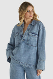 A model wearing the Jordon Top in colour Acidwash (Blue), from the front, cropped image