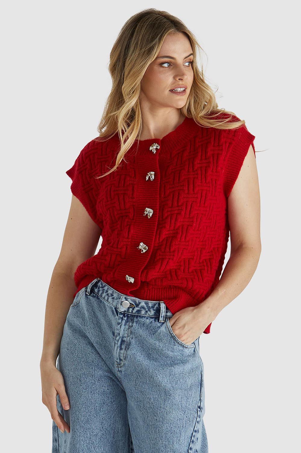 A model wearing the Zadie Vest in colour Poppyred (Red), from the front, cropped image