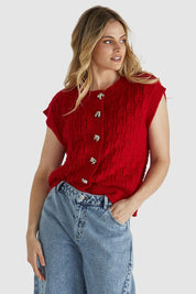 A model wearing the Zadie Vest in colour Poppyred (Red), from the front, cropped image