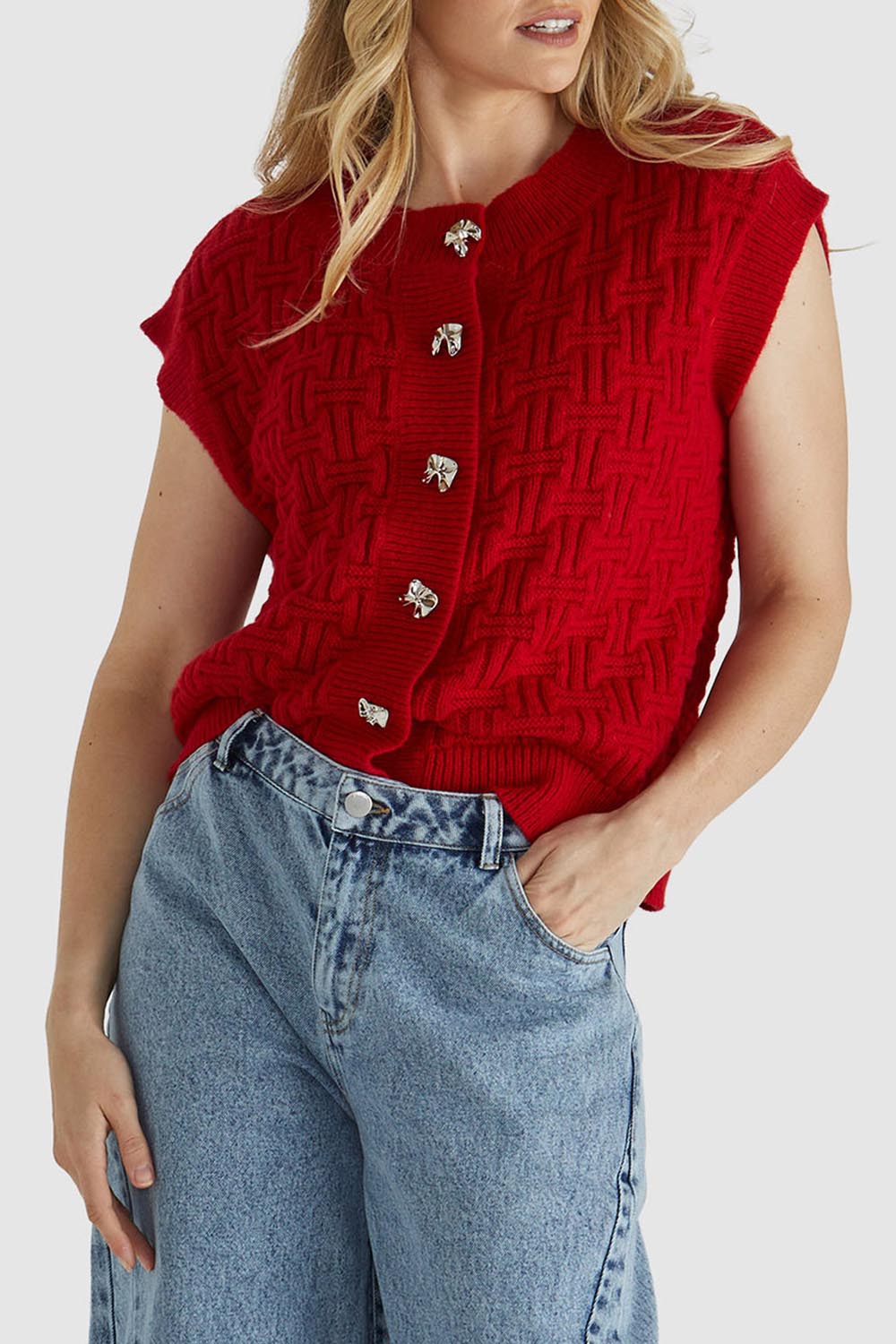 A model wearing the Zadie Vest in colour Poppyred (Red), from the front, cropped image