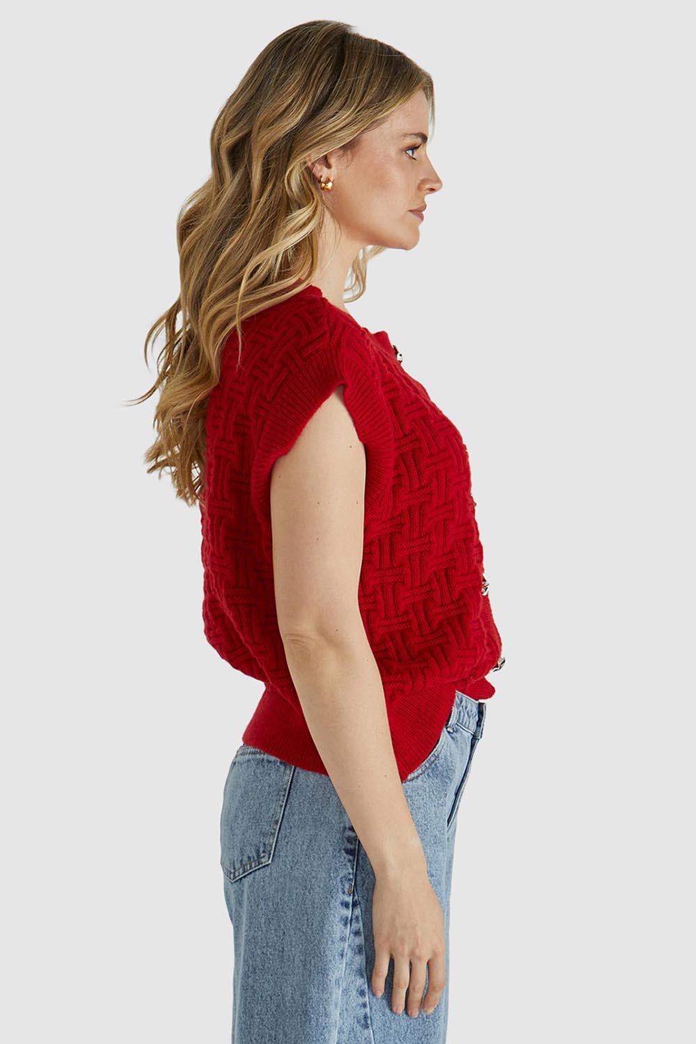 A model wearing the Zadie Vest in colour Poppyred (Red), from the front, cropped image