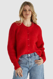 A model wearing the Romee Cardi in colour Poppyred (Red), from the front, cropped image