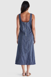 A model wearing the Ainsley Dress in colour Darkdenim (Black), from the back
