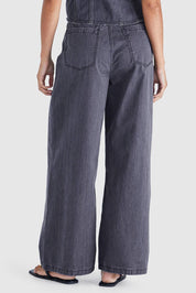A model wearing the Ainsley Jean in colour Darkdenim (Black), from the back