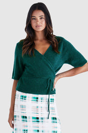 A model wearing the Casey Cardi in colour Teal (Green), from the front, cropped image