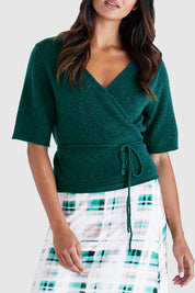 A model wearing the Casey Cardi in colour Teal (Green), from the front, cropped image