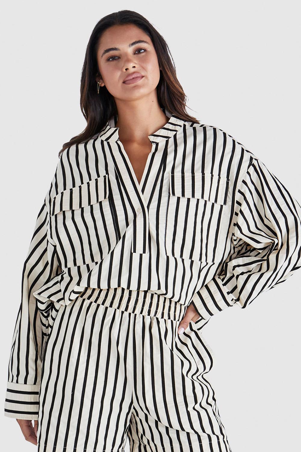 A model wearing the Rohan Cotton Top in colour Stripe, from the front, cropped image