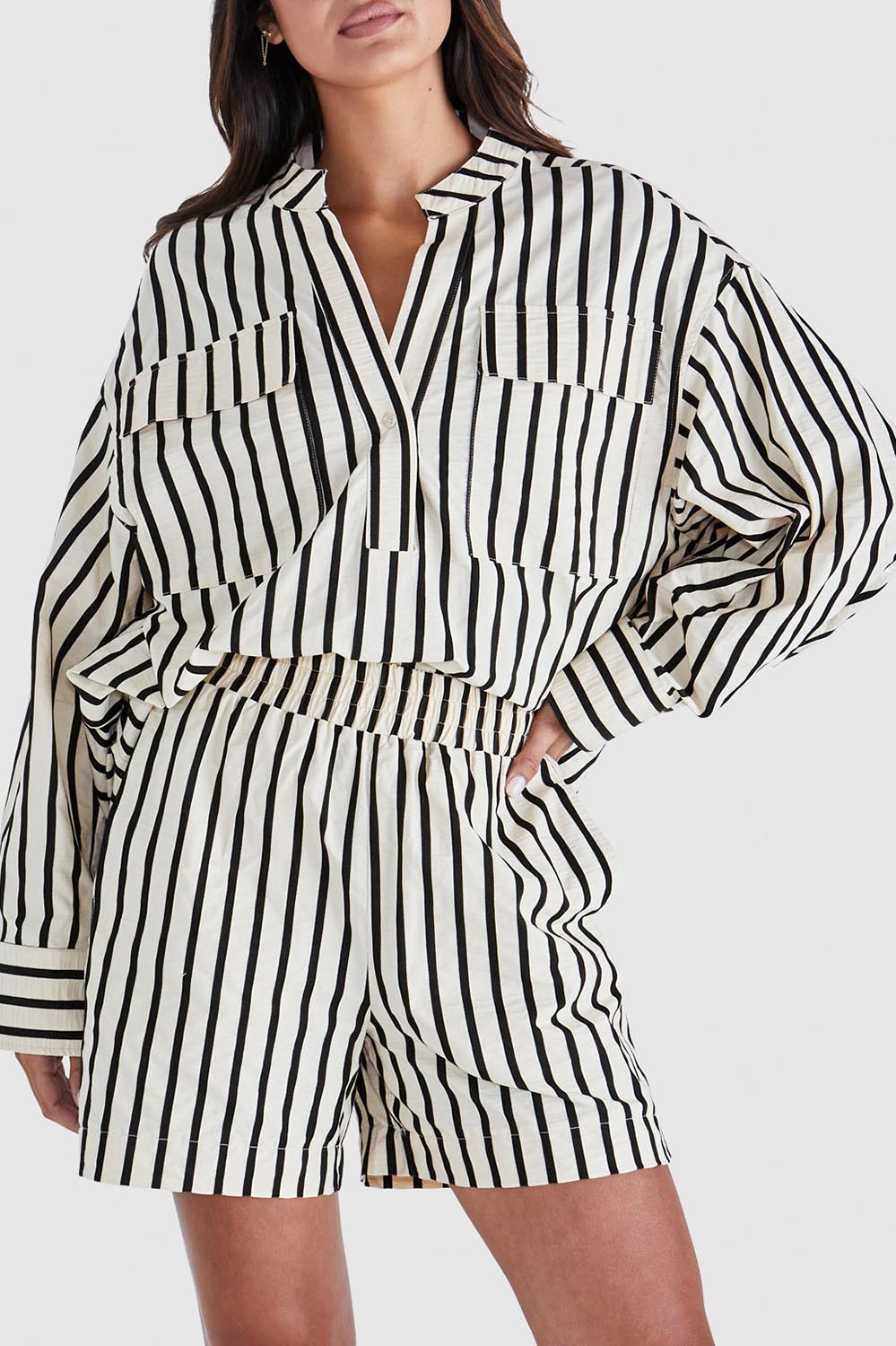 A model wearing the Rohan Cotton Top in colour Stripe, from the front, cropped image