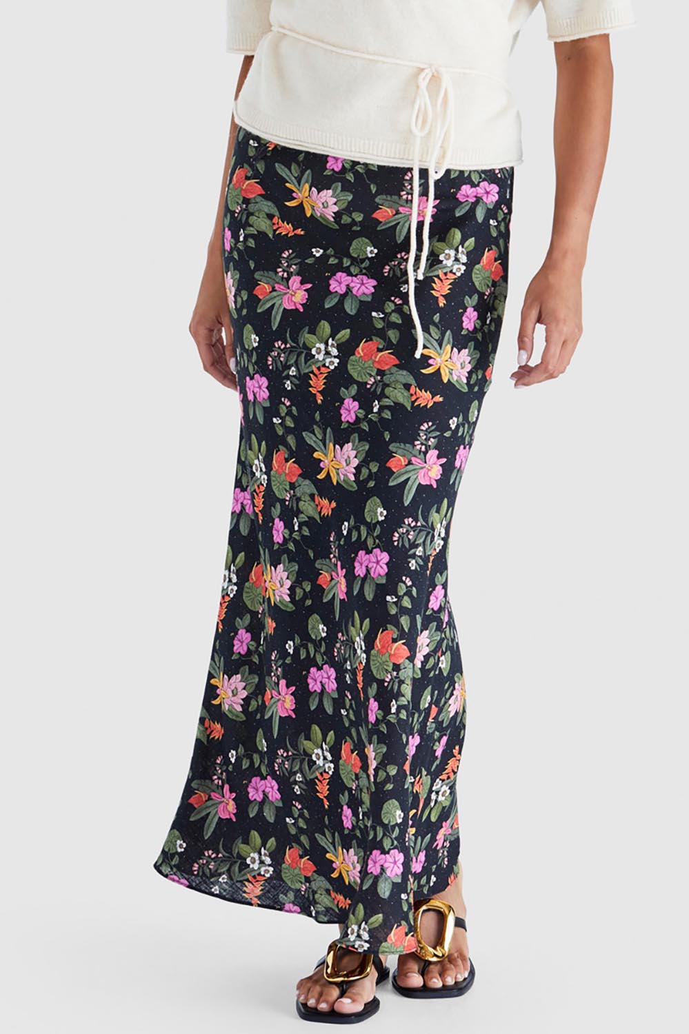 A model wearing the Beckett Bias Skirt in colour Night (Black), from the front, cropped image