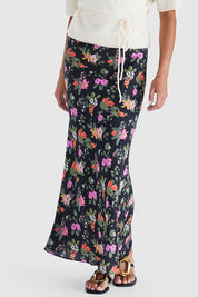 A model wearing the Beckett Bias Skirt in colour Night (Black), from the front, cropped image