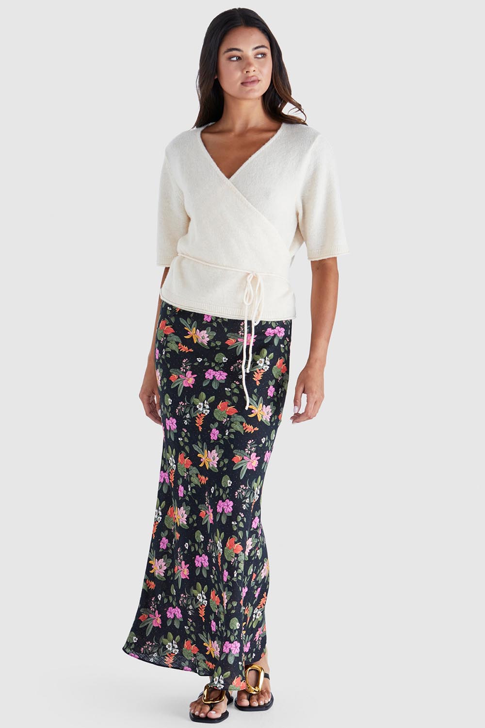 A model wearing the Beckett Bias Skirt in colour Night (Black), from the front, showing the whole outfit