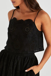 A model wearing the Ani Cotton Cami in colour Black (Black), from the front, cropped image