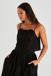 A model wearing the Ani Cotton Cami in colour Black (Black), from the front, cropped image