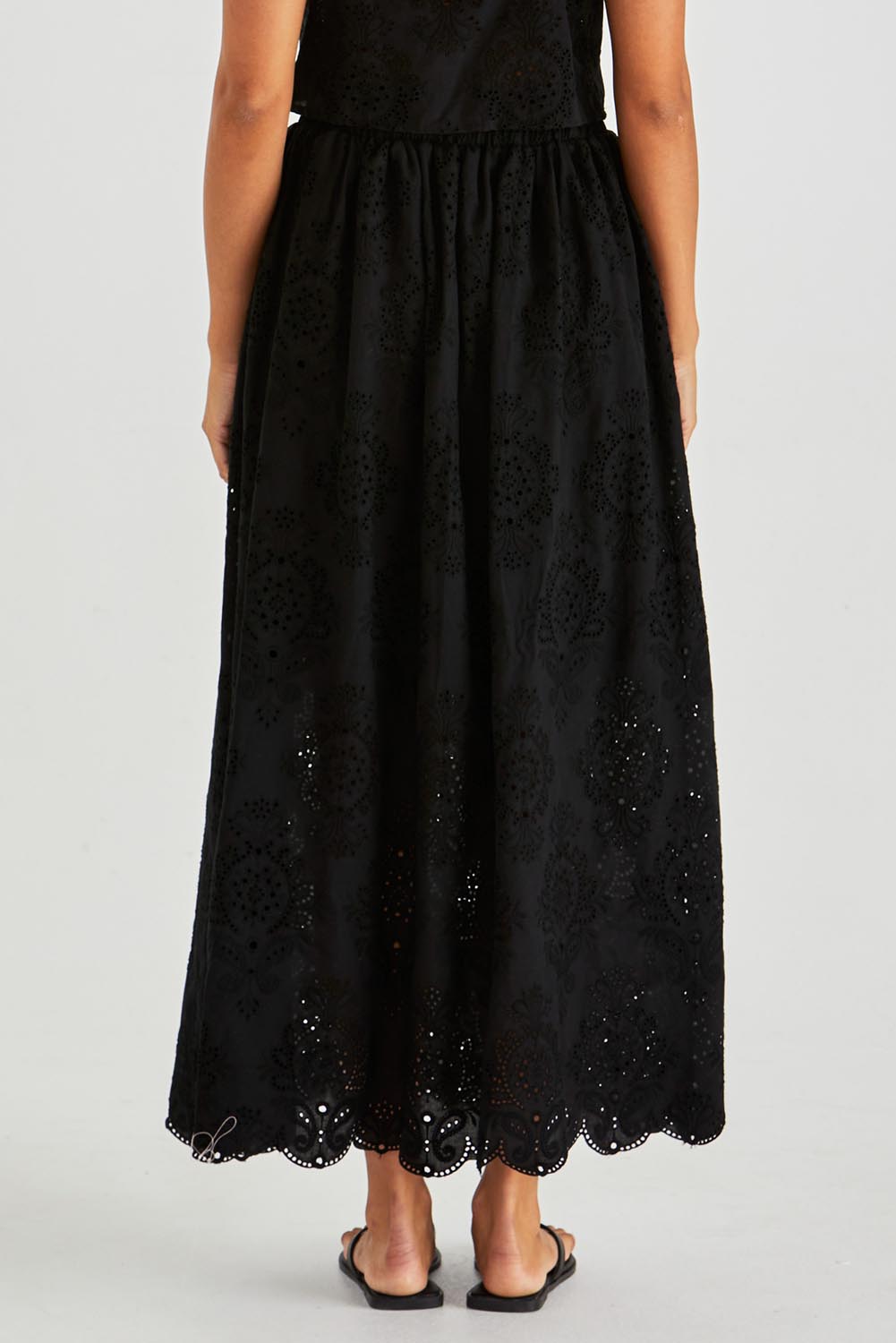 A model wearing the Ani  Cotton Full Skirt in colour Black (Black), from the back