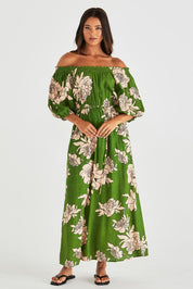A model wearing the Antonie Off Shoulder Dress in colour Moonflower (Green), from the front, showing the whole outfit