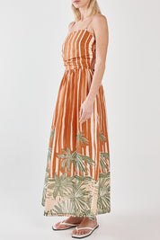 A model wearing the Mina Cotton Strapless Dress in colour Palmstripe, from the front, cropped image