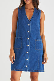 A model wearing the Sabine Denim Vest Dress in colour Midblue (Blue), from the front, cropped image