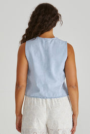 A model wearing the Sabine Denim Vest in colour Bleach (Blue), from the back