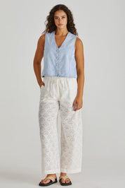A model wearing the Sabine Denim Vest in colour Bleach (Blue), from the front, showing the whole outfit