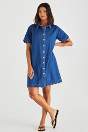 A model wearing the Vale Scalloped Denim Dress in colour Midblue (Blue), from the front, showing the whole outfit
