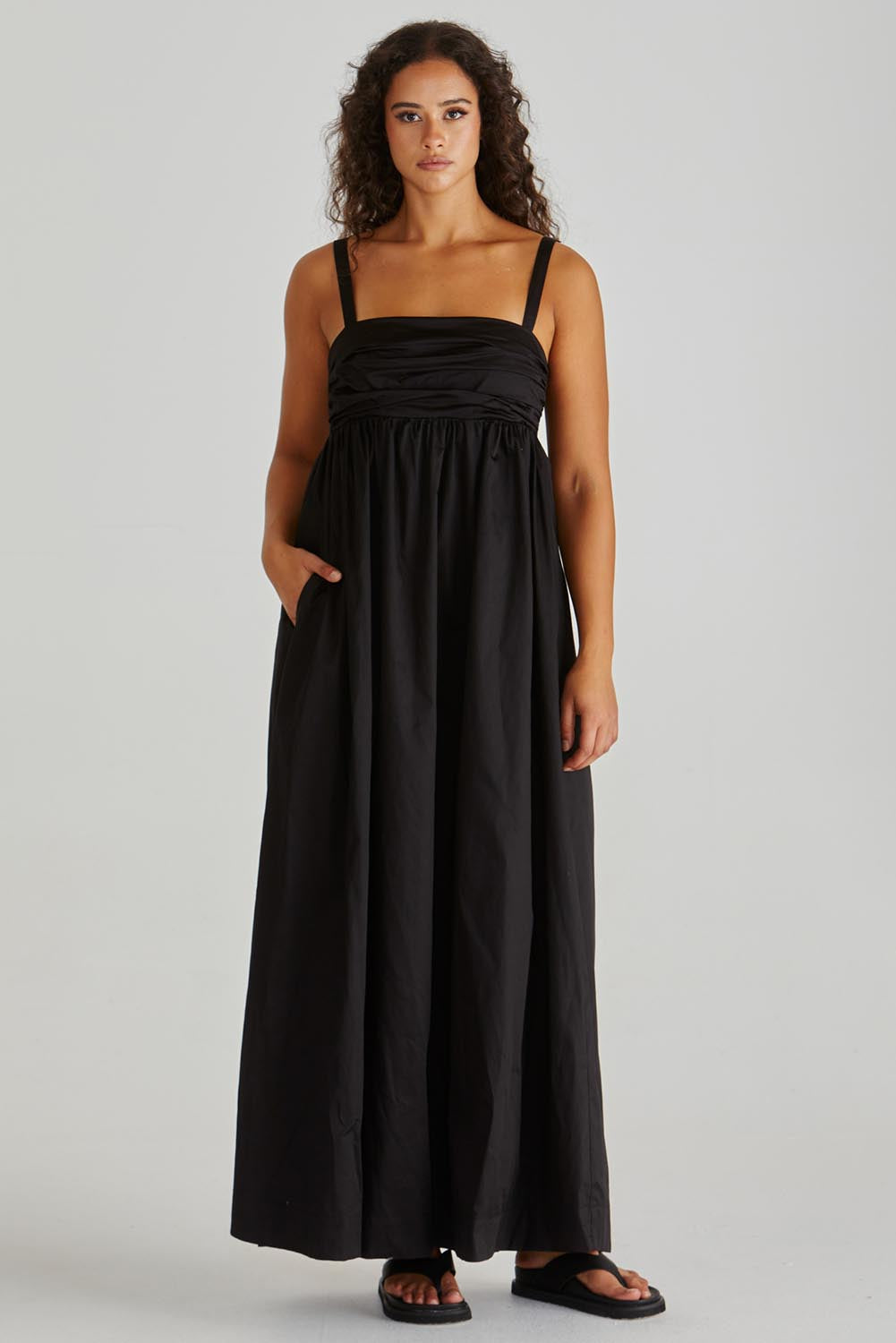 A model wearing the Delaney Cotton Maxi Dress in colour Black (Black), from the front, showing the whole outfit