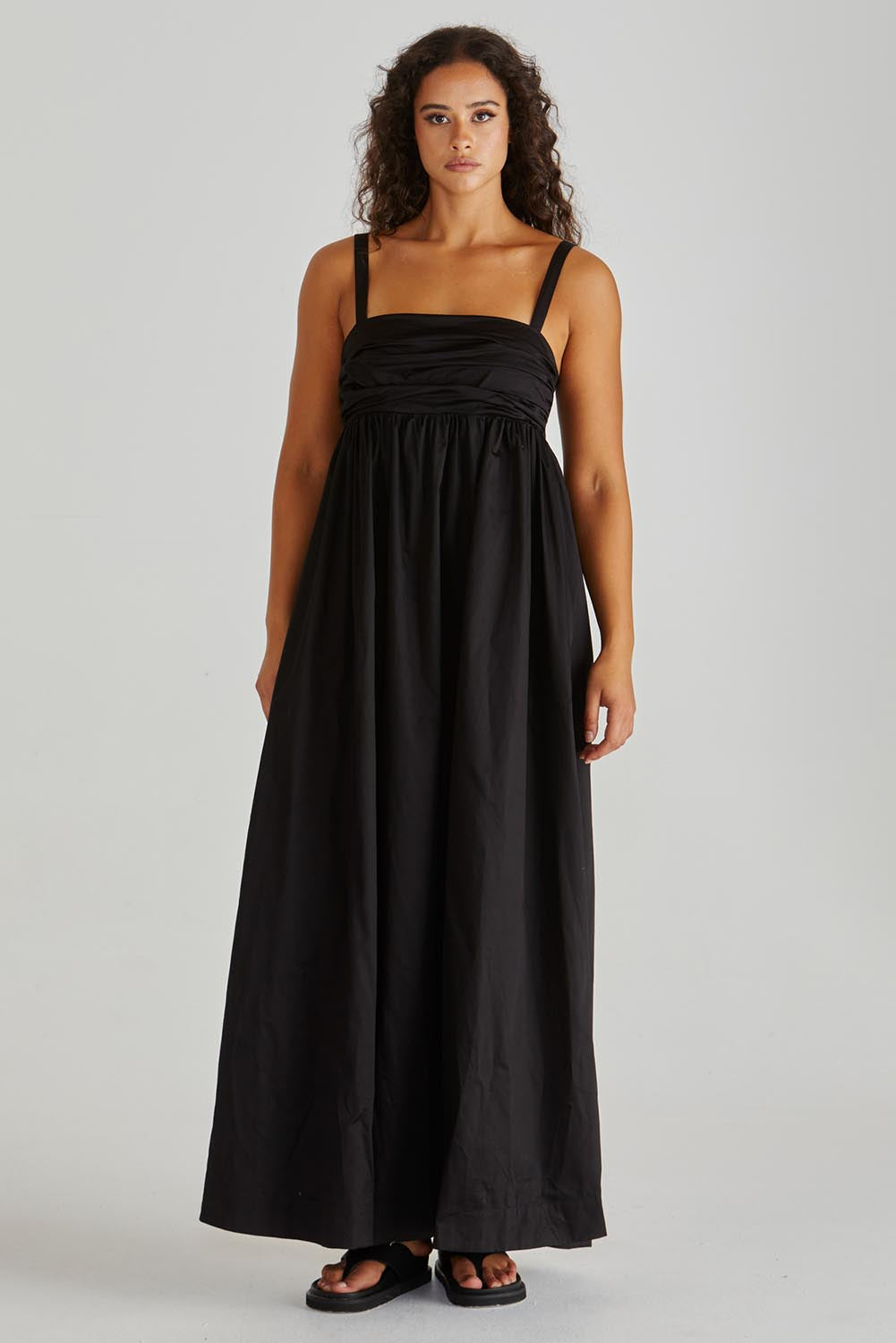 A model wearing the Delaney Cotton Maxi Dress in colour Black (Black), from the front, showing the whole outfit