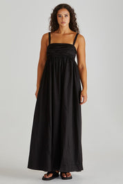 A model wearing the Delaney Cotton Maxi Dress in colour Black (Black), from the front, showing the whole outfit