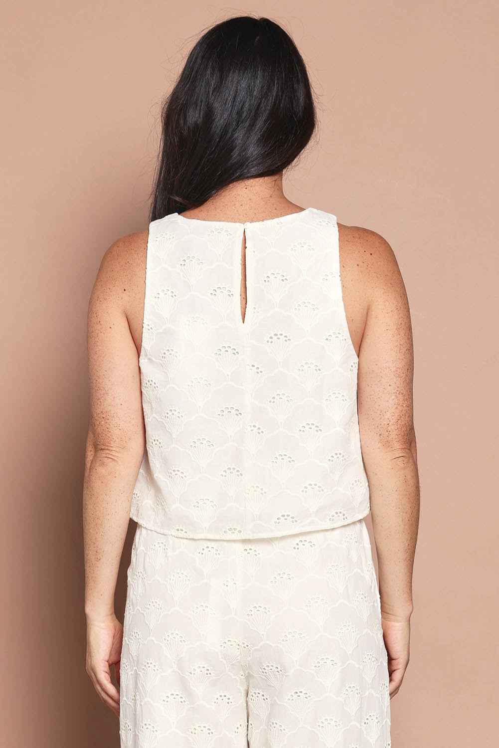 Model Katie wearing size 10 of the Zimmy Broderie Cotton Tank in colour Cream (White), from the back