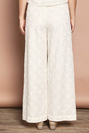 Model Katie wearing size 10 of the Zimmy Broderie Cotton Pant in colour Cream (White), from the back