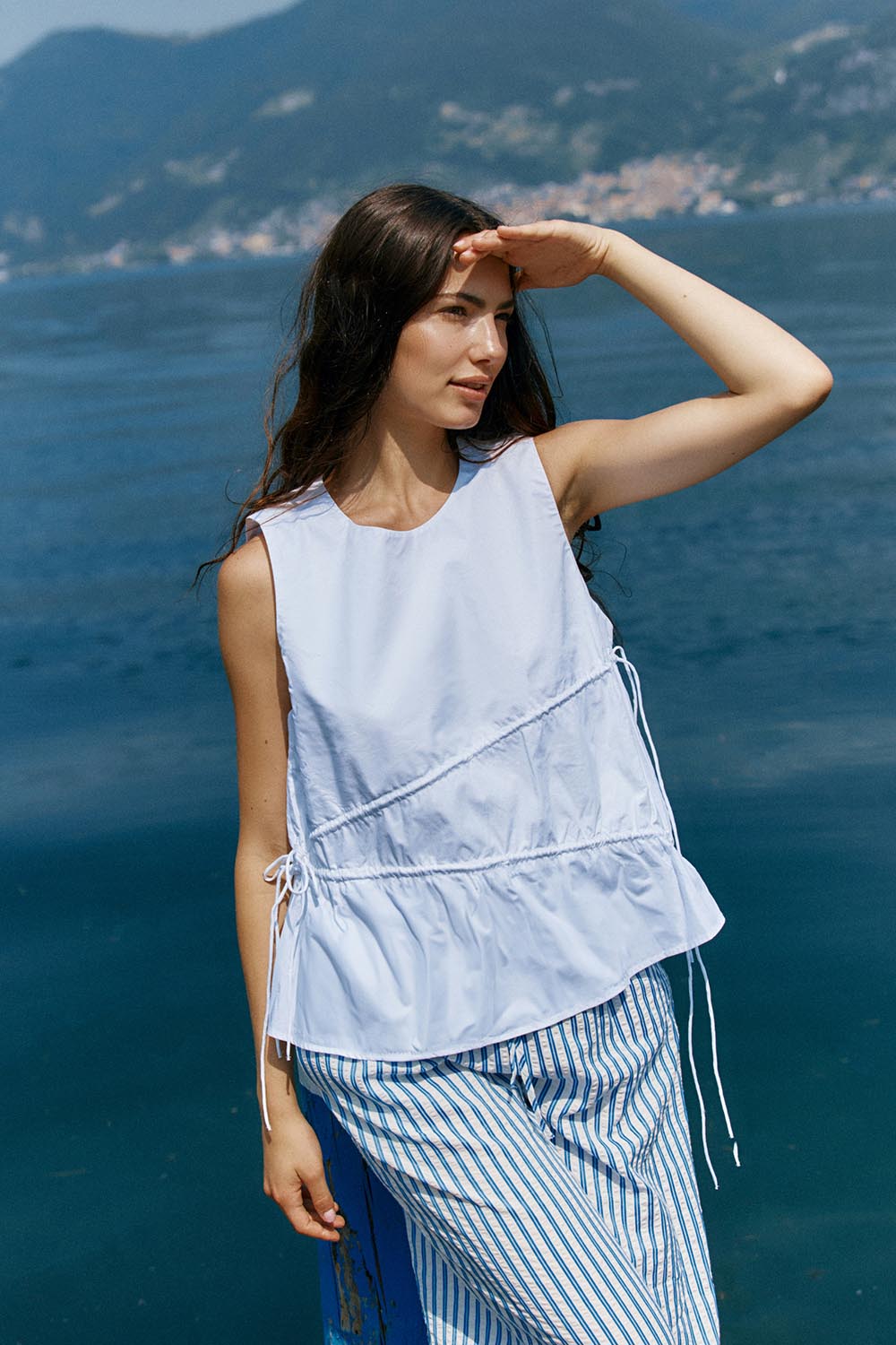 A model wearing the Elin Gathered Tie Top in colour White (White), from the front, showing the whole outfit