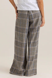 A model wearing the Blakely Pant in colour Check (Grey), from the back