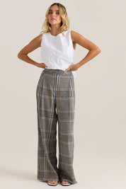 A model wearing the Blakely Pant in colour Check (Grey), from the front, showing the whole outfit