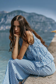 A model wearing the Aziza Gathered Tie Top in colour Bluewhite (Blue), from the front, showing the whole outfit